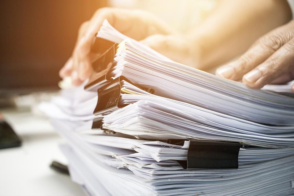 Company Policies & Documents - FlexGenius | Pile of paperwork
