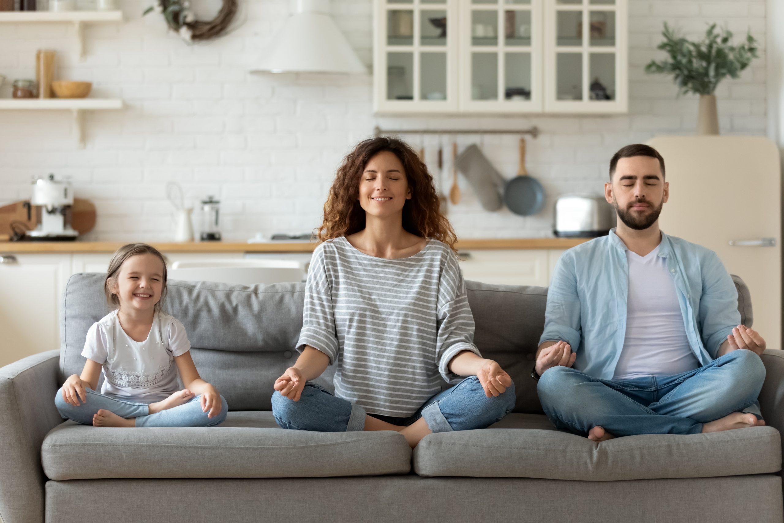 Promoting Financial Wellbeing for Employees | FlexGenius blog | A family meditating