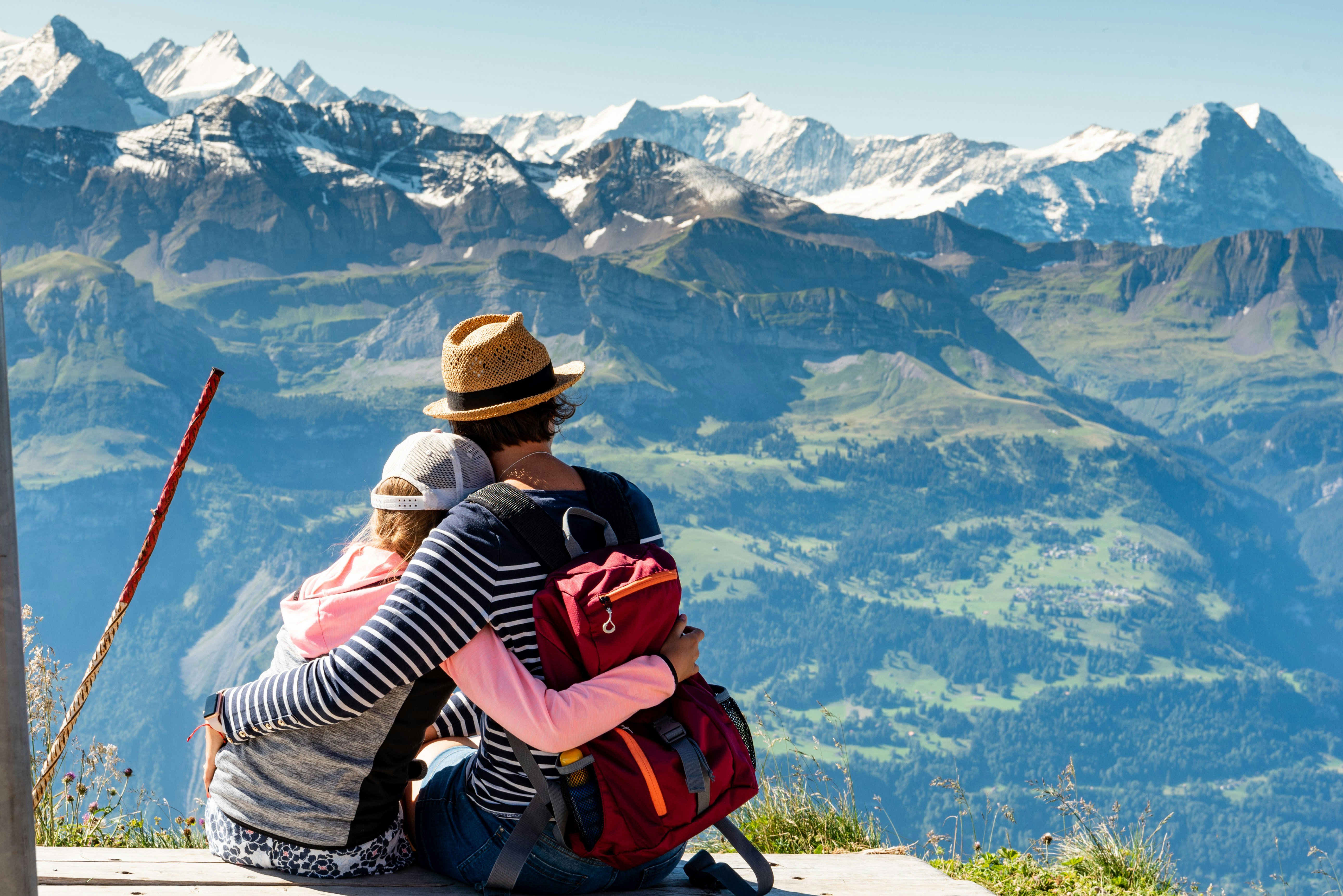Couple relaxing on holiday in front of a beautiful mountain landscape